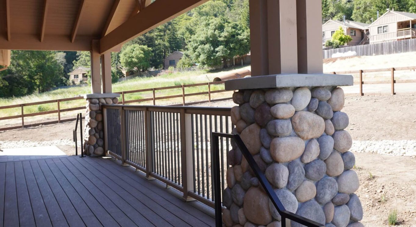 CHP government housing in Big Sur, CA. Modular construction with garage, carports, and paved driveway. Nestled in the forest.