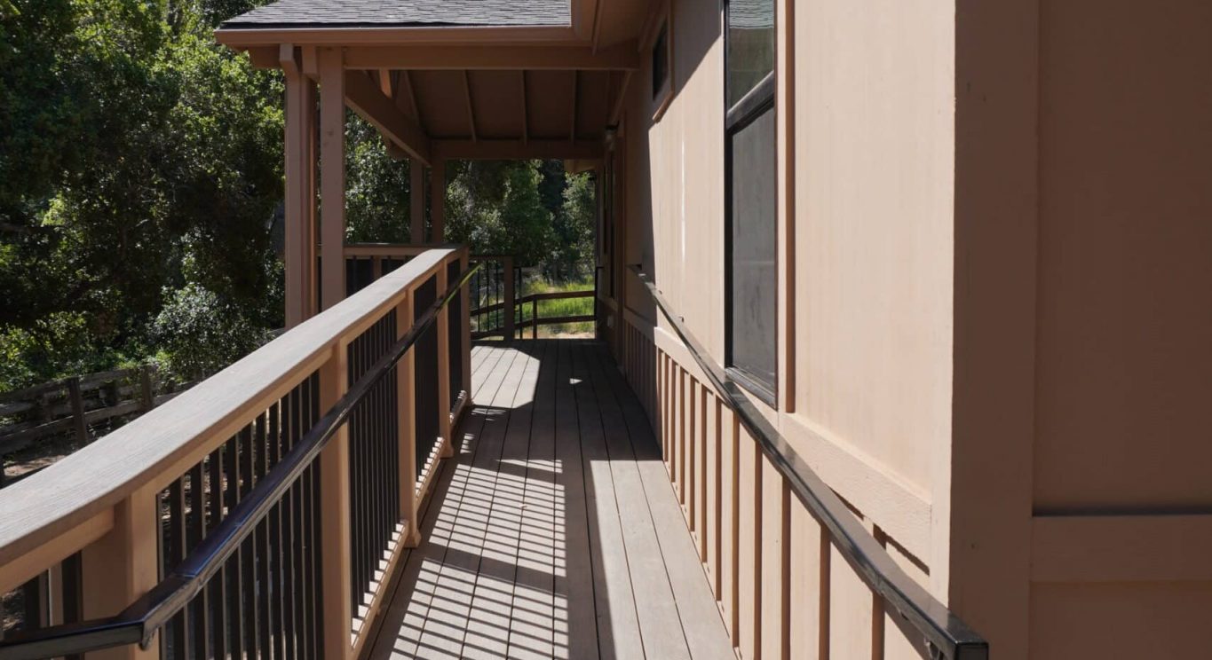 CHP government housing in Big Sur, CA. Modular construction with garage, carports, and paved driveway. Nestled in the forest.