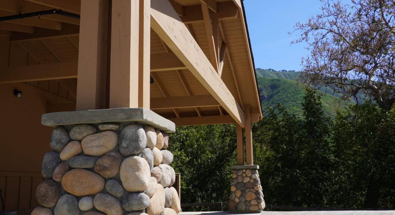 CHP government housing in Big Sur, CA. Modular construction with garage, carports, and paved driveway. Nestled in the forest.