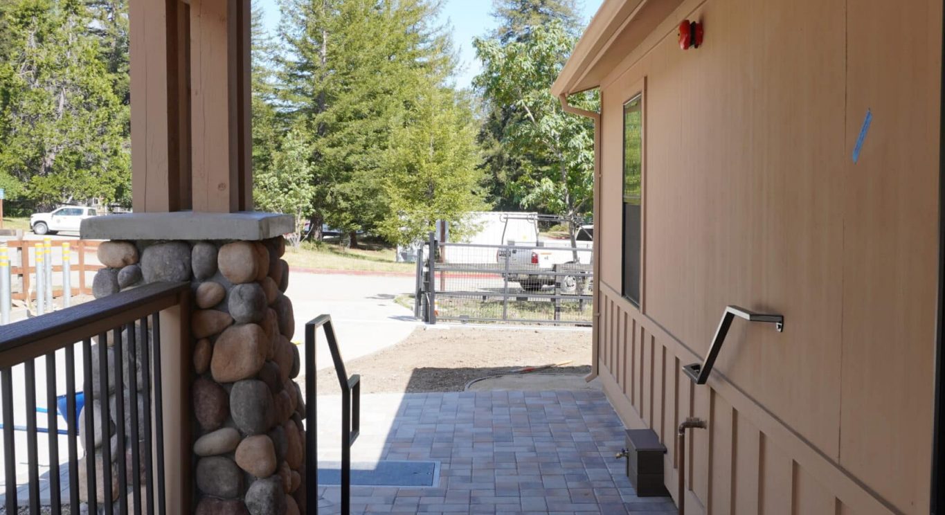 CHP government housing in Big Sur, CA. Modular construction with garage, carports, and paved driveway. Nestled in the forest.