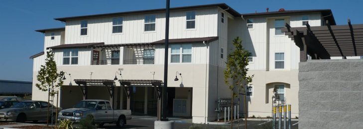 Mixed use commercial & residential building. Brown roof & cream walls in a modern design.