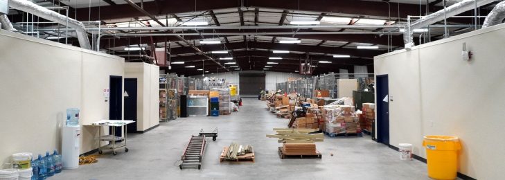 The inside of a warehouse facility, showing pallets, packages, and storage equipment.
